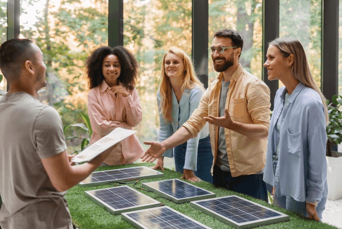 Partners discussing clean-energy solutions around a display of solar panels